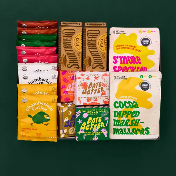 gift box full of shareable snacks on a dark green background