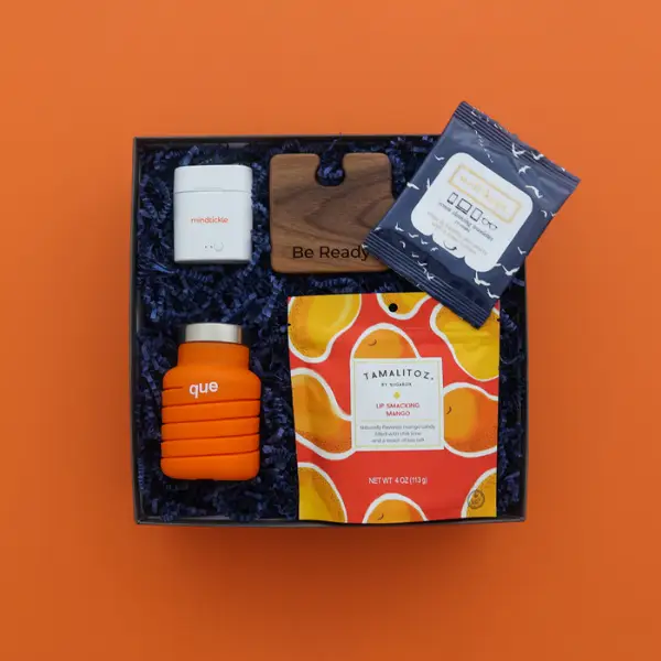 branded air pods inside a gift box on an orange background