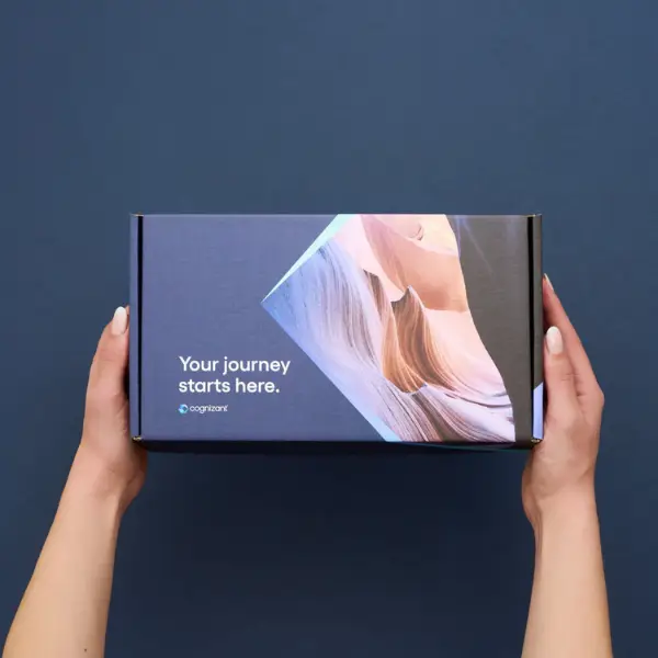hands holding a custom branded mailer box on a blue background
