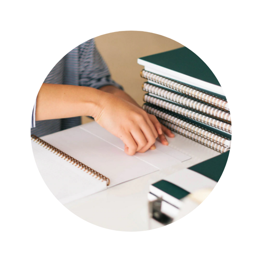 applying-sticker-to-notebook - Teak & Twine