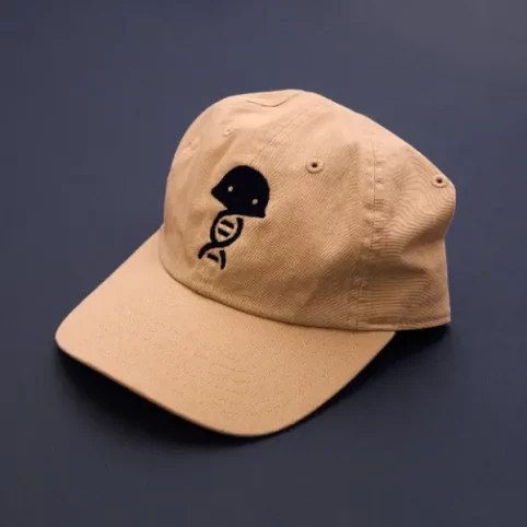 branded-hat custom branded beige baseball cap with logo on a navy blue background