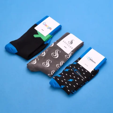 custom-branded-socks three pairs of custom branded socks on a pale blue background